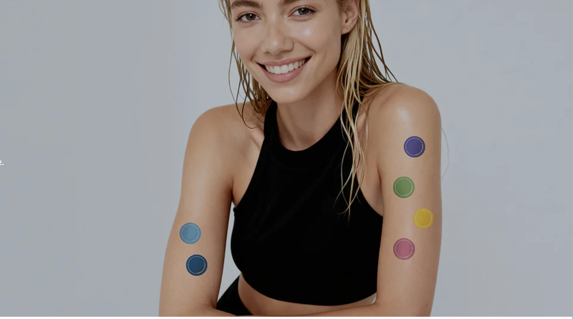Smiling woman wearing colorful Gentle Patches on her arms